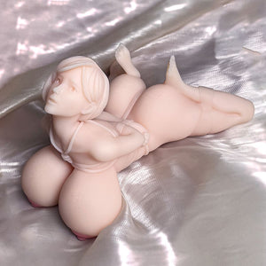 Bondage anime figurine onahole Anna lying on the bed, looking at the top